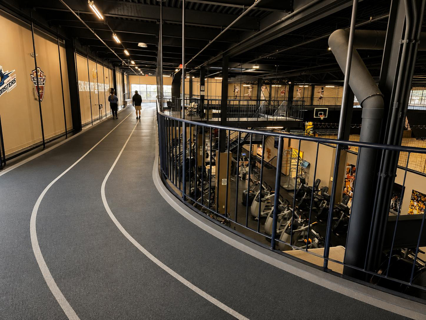 Rubber-cushioned indoor running track at Cleveland Fitness Club with multiple lanes for walking and running